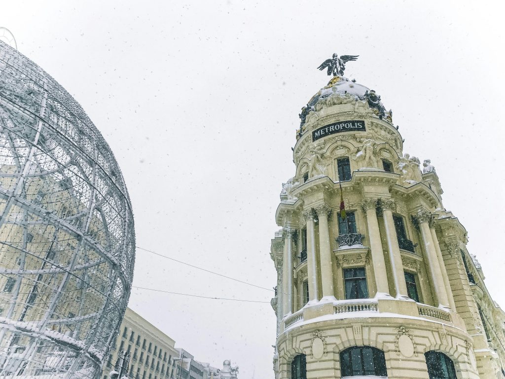 pexels photo 9470337 9470337 Low-angle shot of the Metropolis Building in Madrid during a snowy winter day.
